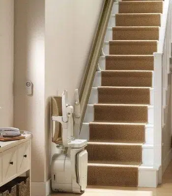 Folded, the Siena stairlift leaves room for people to walk up and down the stairs.